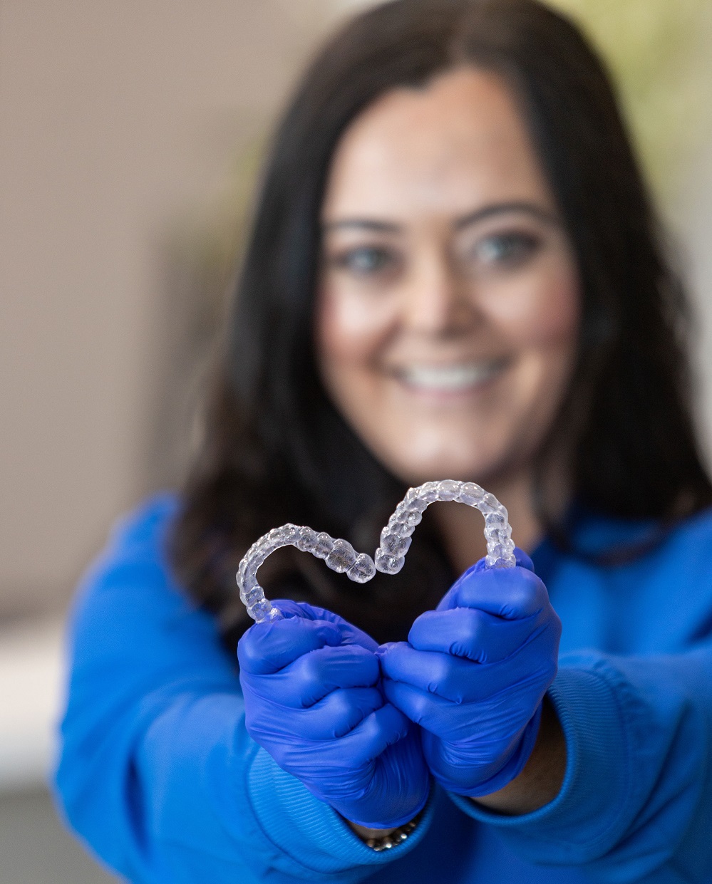 Auburn dentist holding Clear Aligners at Thrive Family Dentistry